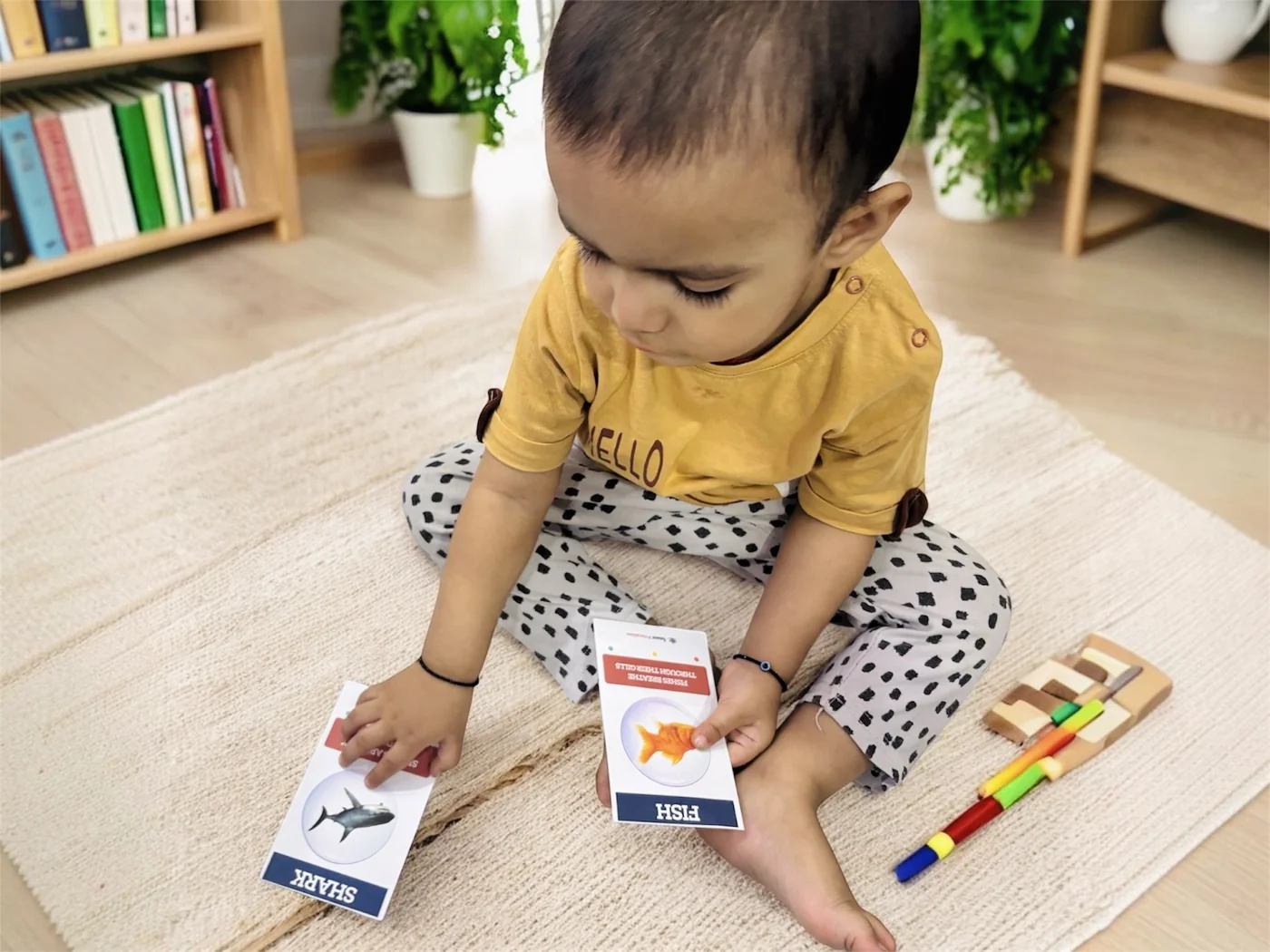 A young child playing with Anant Printables flashcards